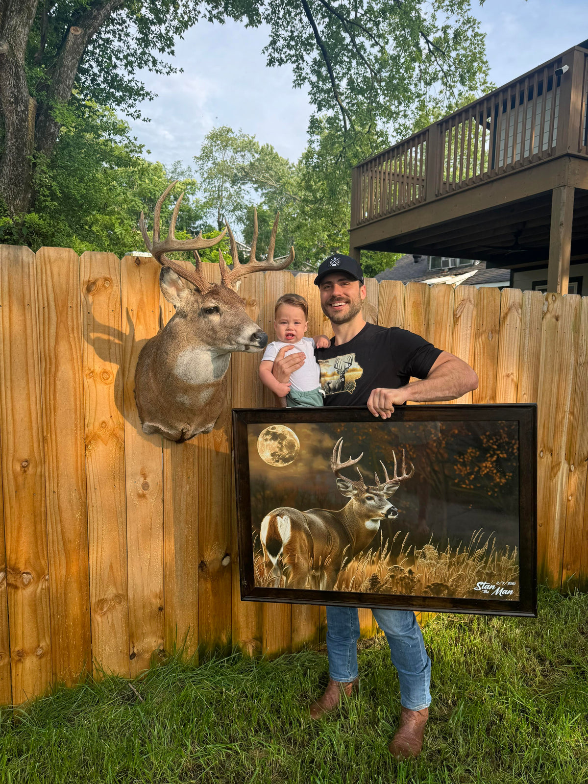 Hunt Local founder holding his framed custom deer art beside the real shoulder mount of the same buck